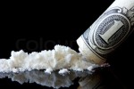 Cocaine and dollar on black background